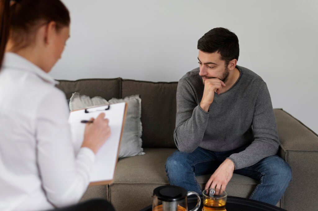 Man in therapy session discussing mental health concerns with therapist – is depression therapy worth it