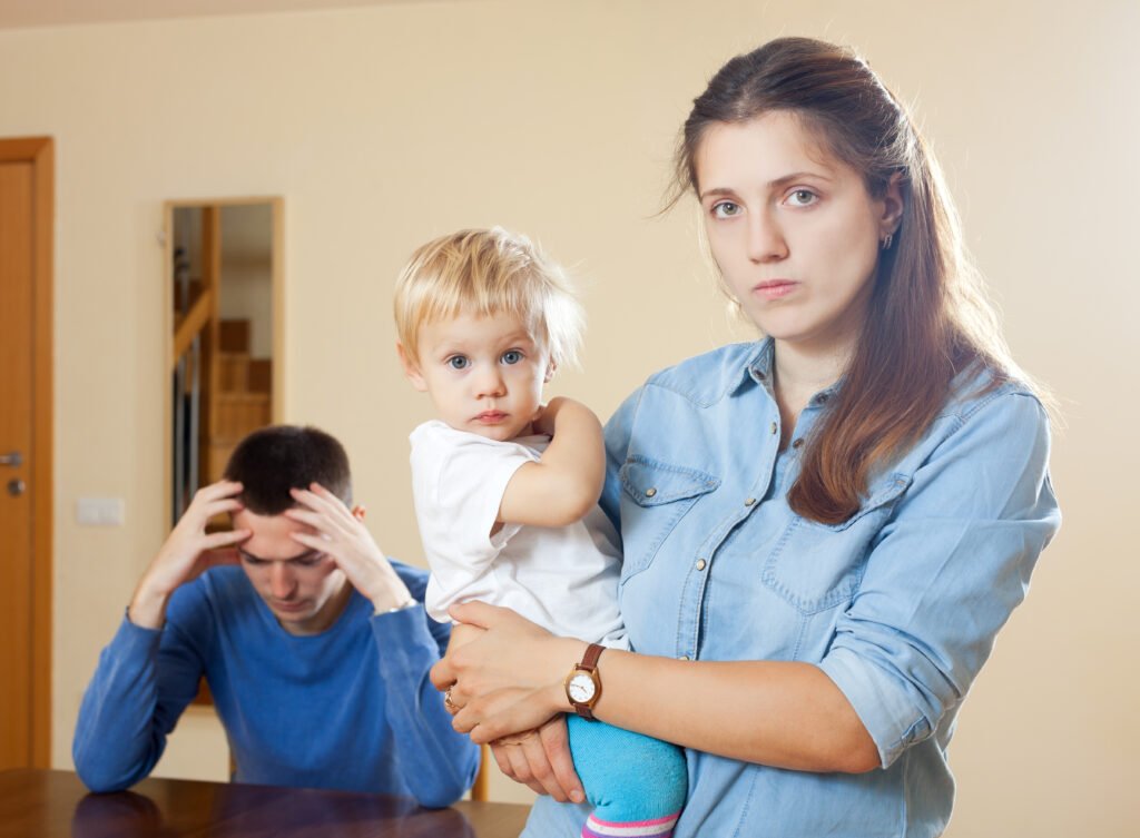 Overwhelmed parents managing stress and emotional pressure while caring for a young child